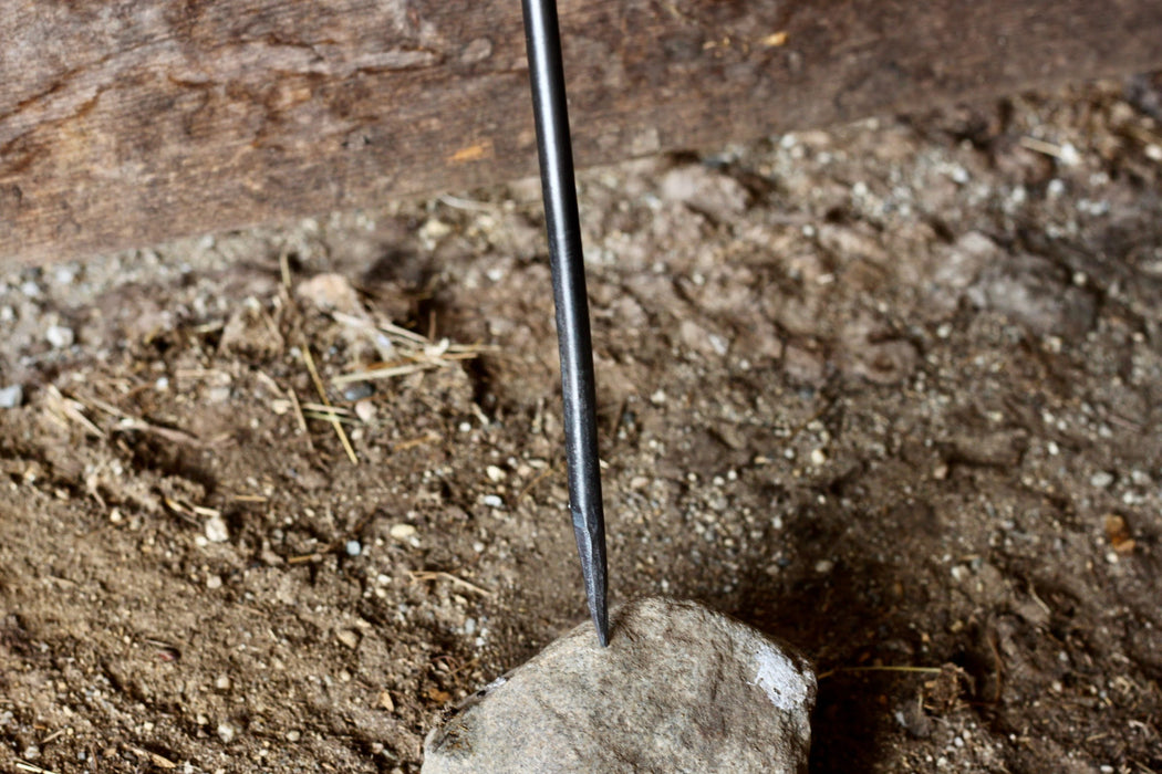 a blacksmith hand forged fire poker with a leaf wrap design by Wicks Forge