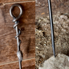 a blacksmith hand forged fire poker with a leaf wrap design by Wicks Forge