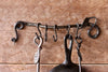 a blacksmith hand forged pot and pan rack with a leaf design by Wicks Forge