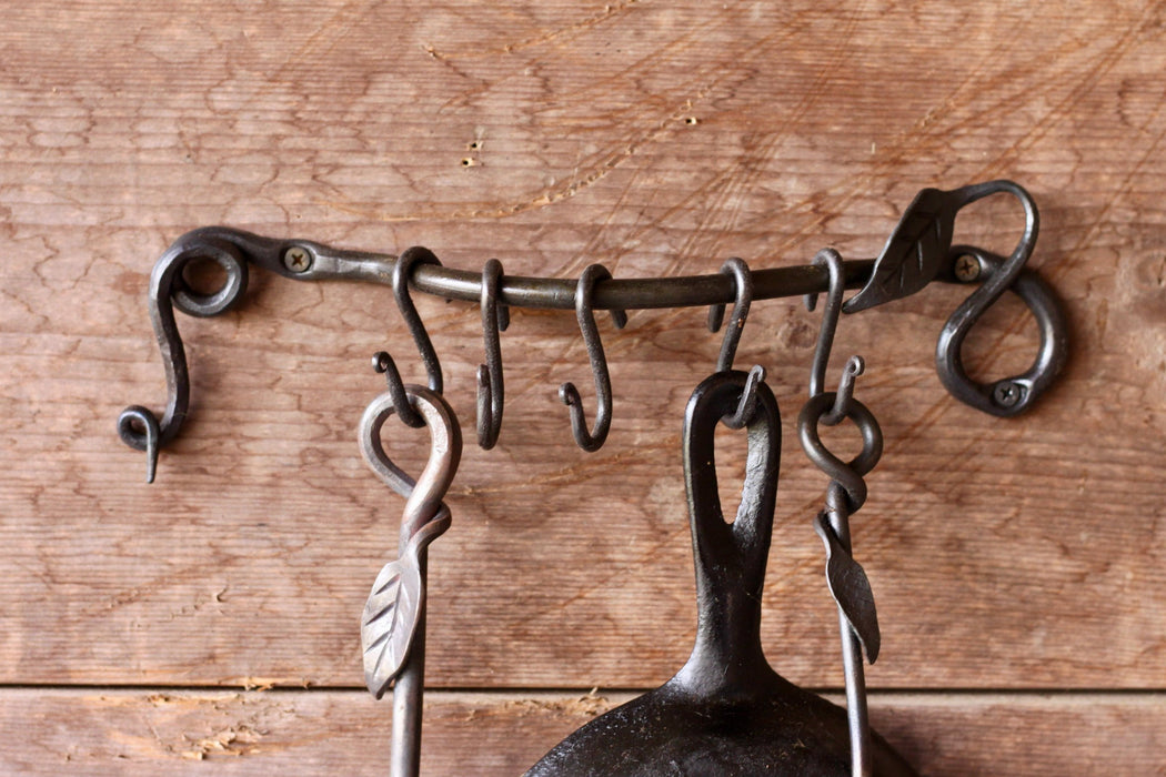a blacksmith hand forged pot and pan rack with a leaf design by Wicks Forge