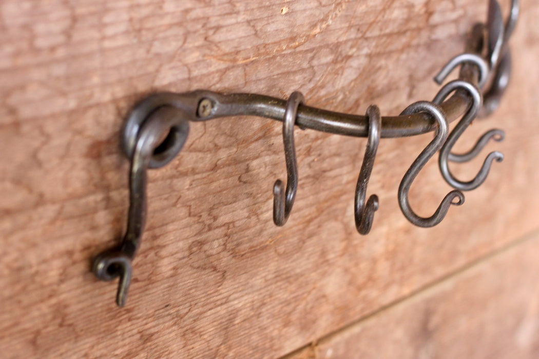 a blacksmith hand forged pot and pan rack with a leaf design by Wicks Forge