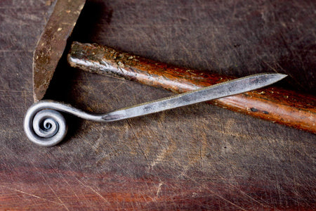 a blacksmith hand forged letter opener with a fiddlehead spiral handle by Wicks Forge