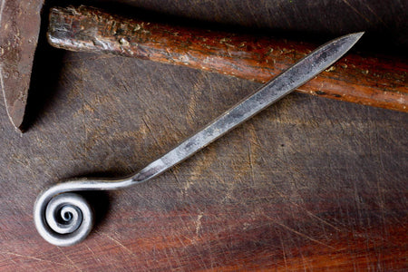 a blacksmith hand forged letter opener with a fiddlehead spiral handle by Wicks Forge