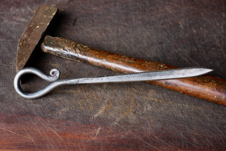 a blacksmith hand forged letter opener with a reverse curl handle by Wicks Forge