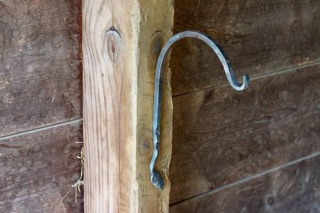 a blacksmith hand forged plant hanger with a leaf design by Wicks Forge