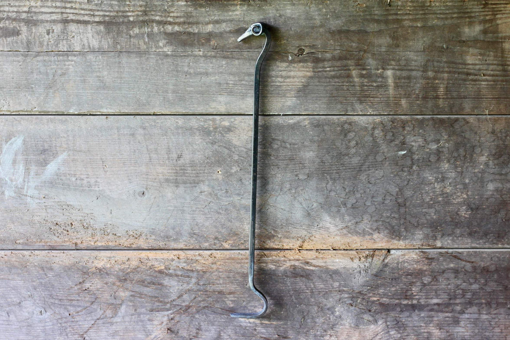a blacksmith hand forged fire poker with a ram's head detail by Wicks Forge
