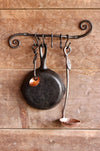 a blacksmith hand forged pot and pan holder with a scrolled design by Wicks Forge