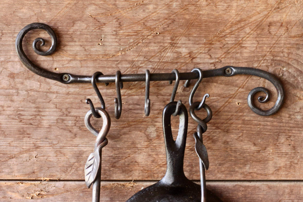 a blacksmith hand forged pot and pan holder with a scrolled design by Wicks Forge