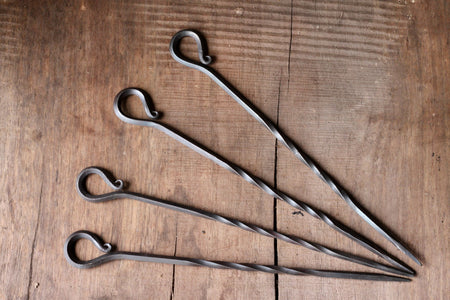 A set of hand forged iron Skewers with desired scroll handle by Wicks Forge