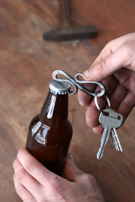 a blacksmith hand forged small keychain bottle opener by Wicks Forge