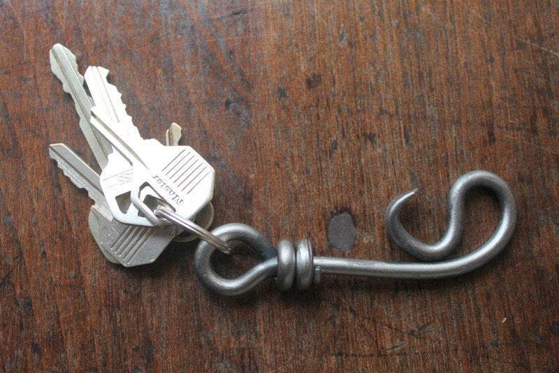 a blacksmith hand forged keychain bottle opener by Wicks Forge