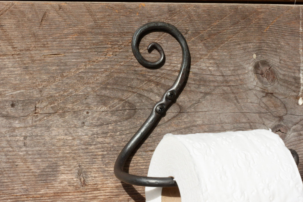 a blacksmith hand forged toilet paper holder with a curl detail by Wicks Forge